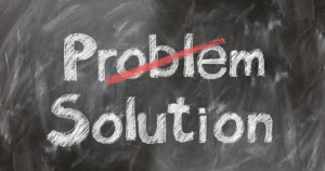 Ckalk board illustrating the words solution overriding problem.