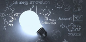 Tablets education. Picture of a bright light bulb illuminating strategy, innovation and creativity.