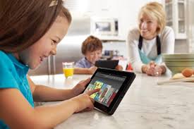 Electronic learning devices for kids. The picture of a Mother and her kids engaging their fun learning devices.